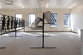 A room with a row of sculptures in the middle of it 